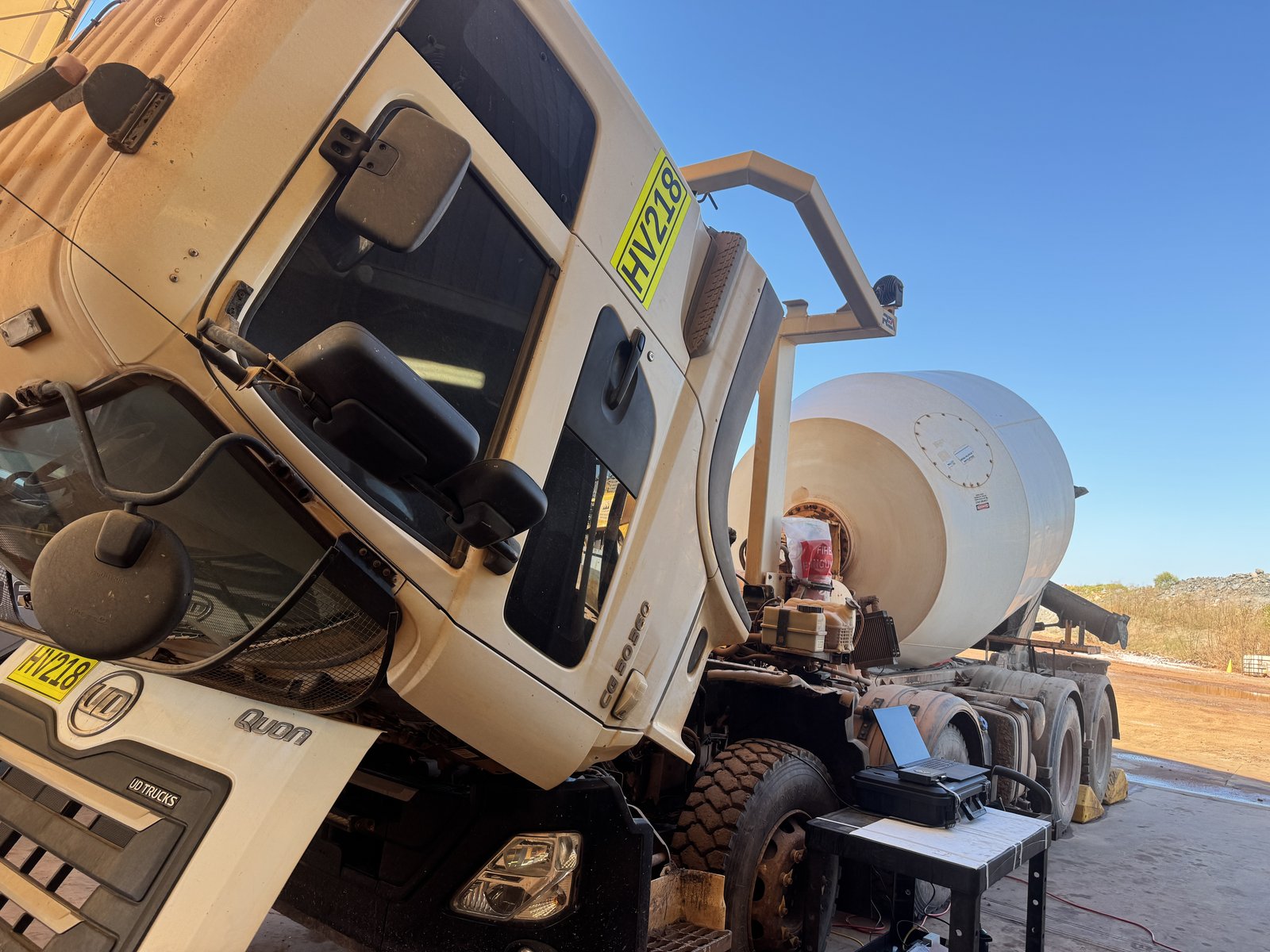 Cab-up concrete mixer with workshop laptop on a stand