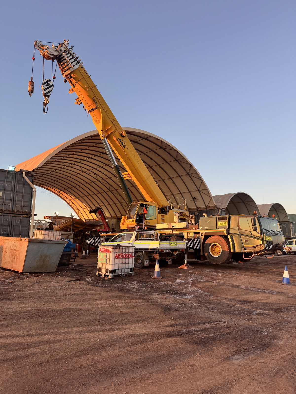 Mobile crane and workshop shed at last light